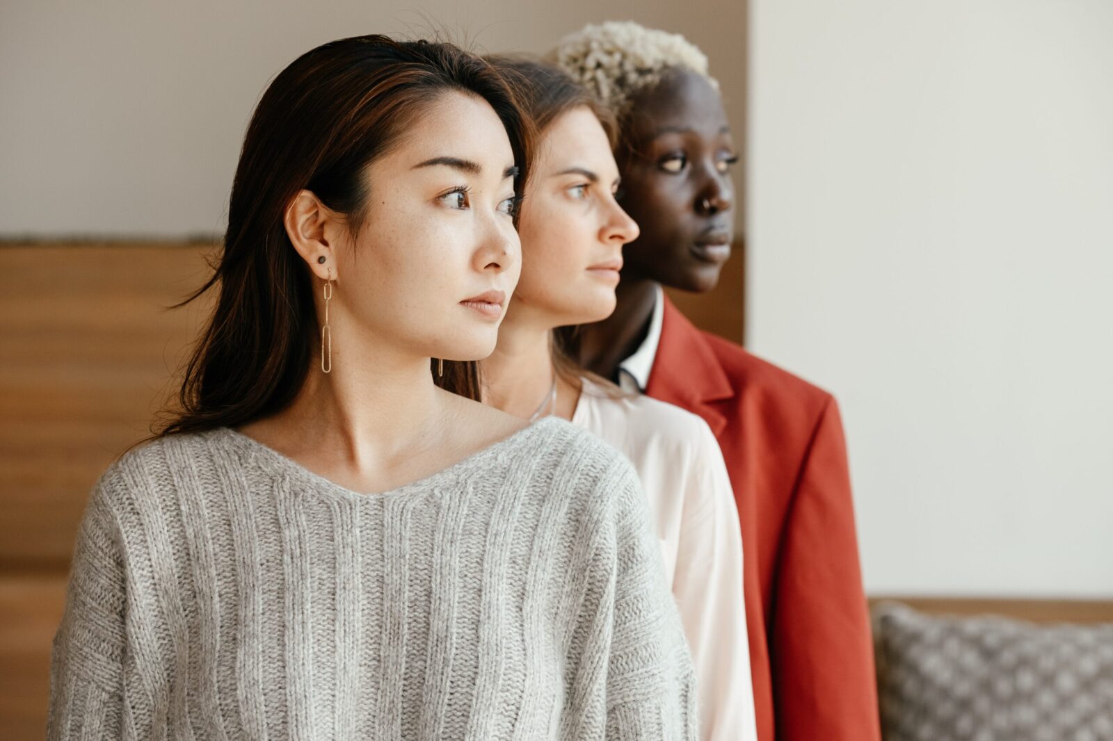 three woman looking to the left of the camera