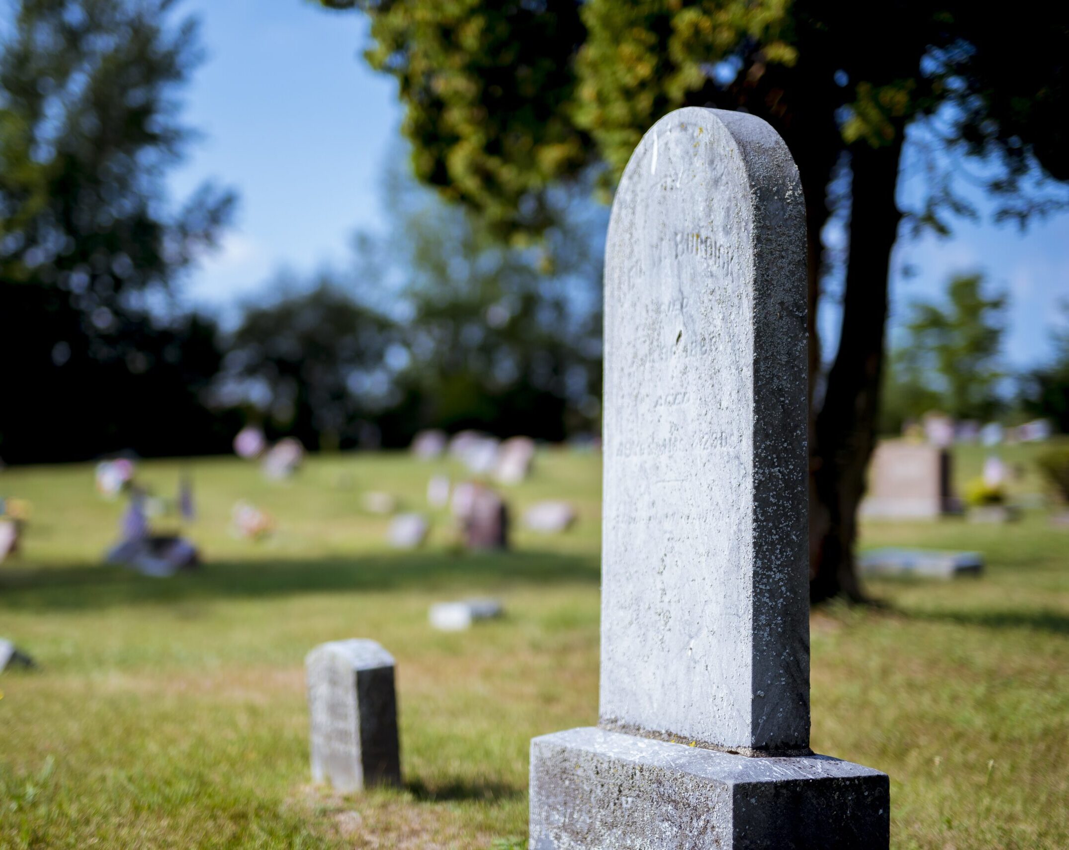 Family visiting the grave of a loved one while working with a Missouri Probate Lawyer.
