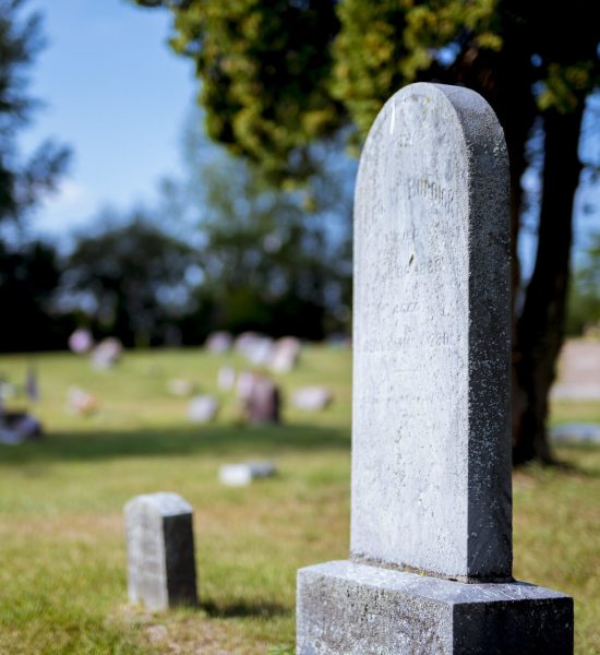 Family visiting the grave of a loved one while working with a Missouri Probate Lawyer.